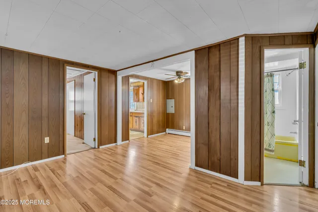 a view of a room with wooden floor and entryway