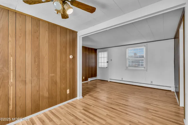 a view of an empty room with wooden floor