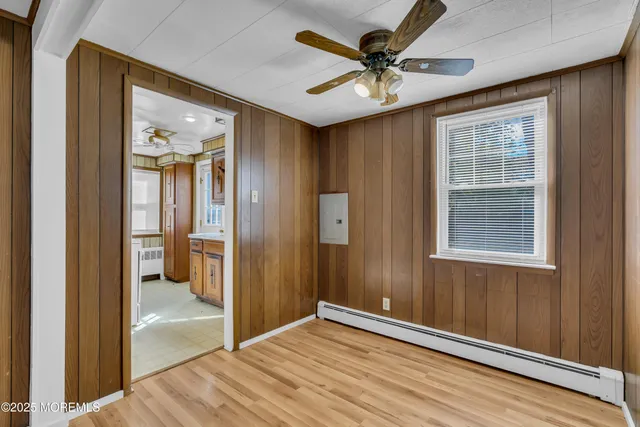 wooden floor in an empty room with a mirror