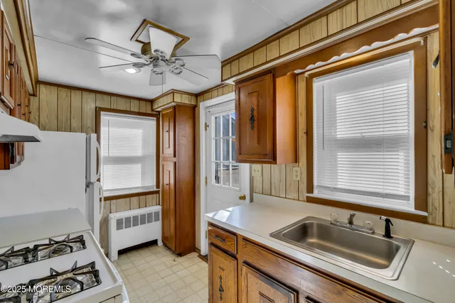 a kitchen with a refrigerator a sink and a window