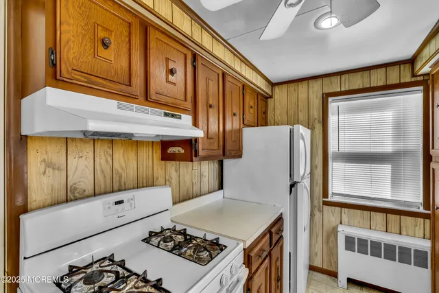 a kitchen with stainless steel appliances granite countertop a refrigerator and a stove