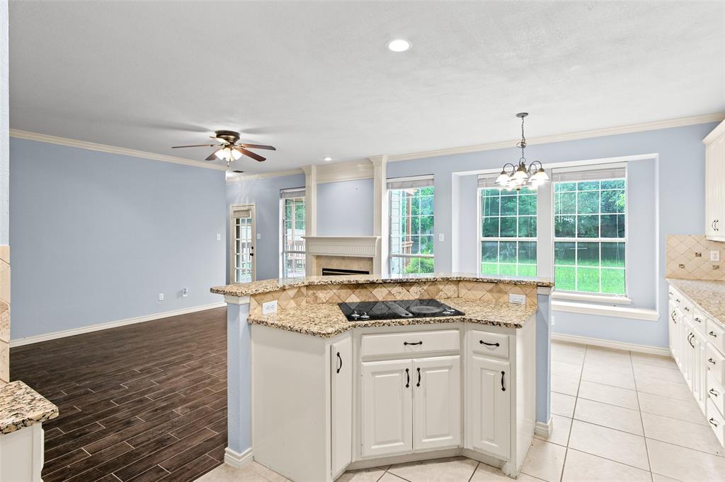 2604 Ridgewood Drive Plano, TX 75074 - Photo 16 of 35 Kitchen island with an integrated cooktop and granite countertops