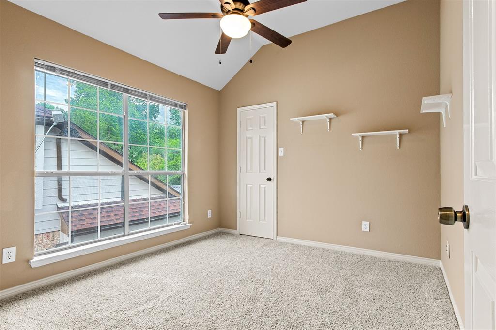 2604 Ridgewood Drive Plano, TX 75074 - Photo 25 of 35 Carpeted room featuring a vaulted ceiling and a large window with grid panes