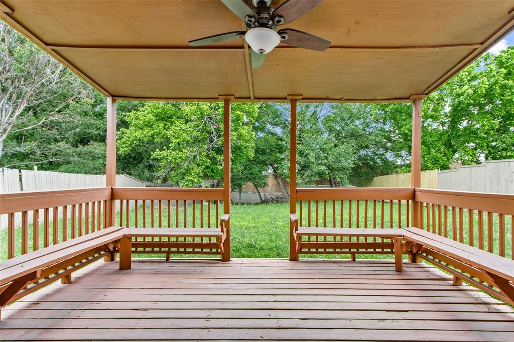 2604 Ridgewood Drive Plano, TX 75074 - Photo 32 of 35 Expansive covered deck featuring wood decking, integrated wood benches, and a ceiling fan