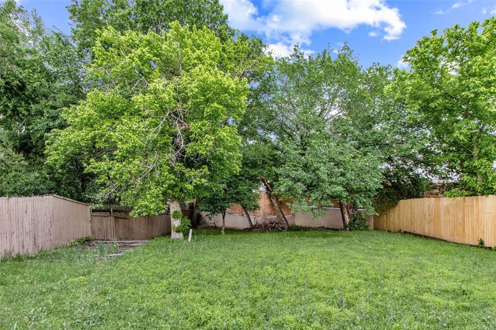 2604 Ridgewood Drive Plano, TX 75074 - Photo 35 of 35 Spacious grassy yard featuring mature trees and wood fencing