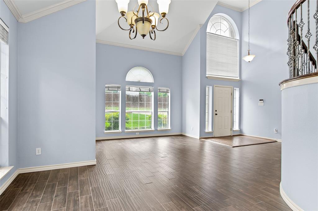 2604 Ridgewood Drive Plano, TX 75074 - Photo 7 of 35 Vaulted ceiling entry foyer featuring wood-finish flooring, a decorative chandelier, and a prominent arched window above the front door