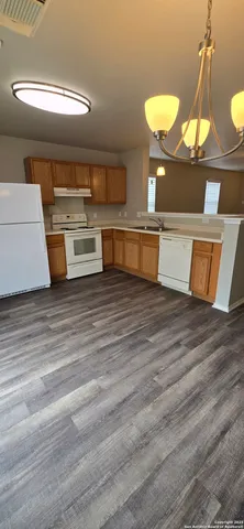 a view of a room with kitchen island and a chandelier