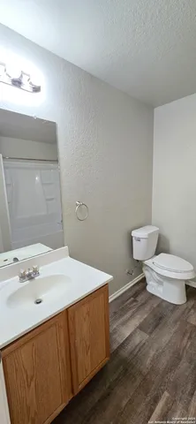 a bathroom with a sink a toilet and a mirror