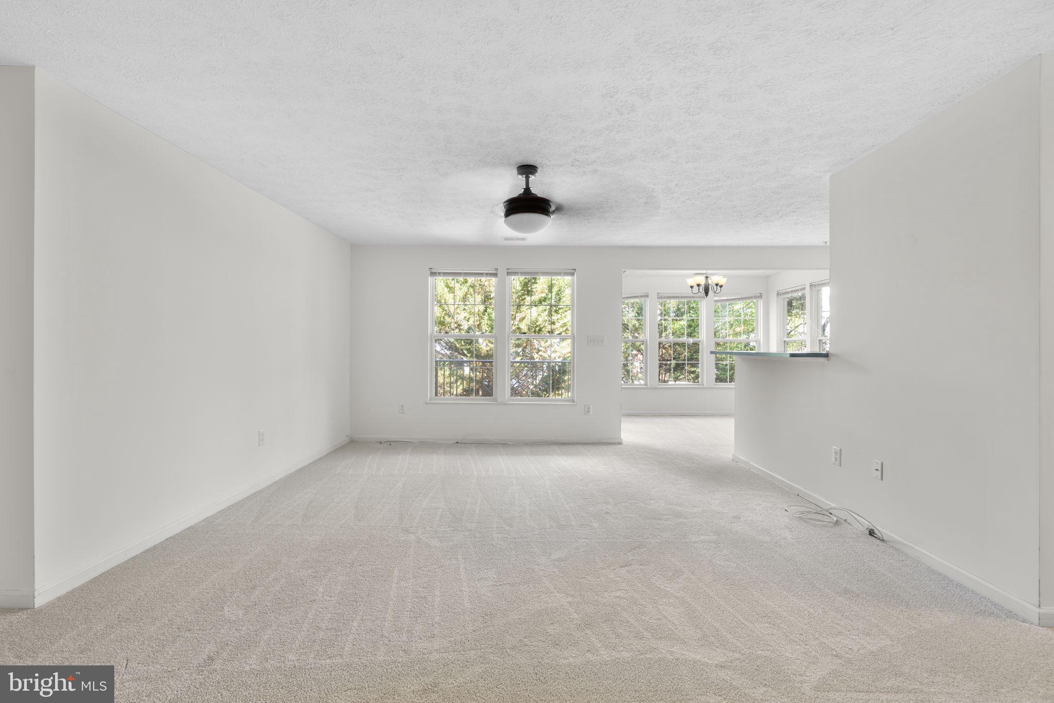 2444 Blue Spring Court, Unit 203 Odenton, MD 21113 - Photo 5 of 36 an empty room with windows and windows