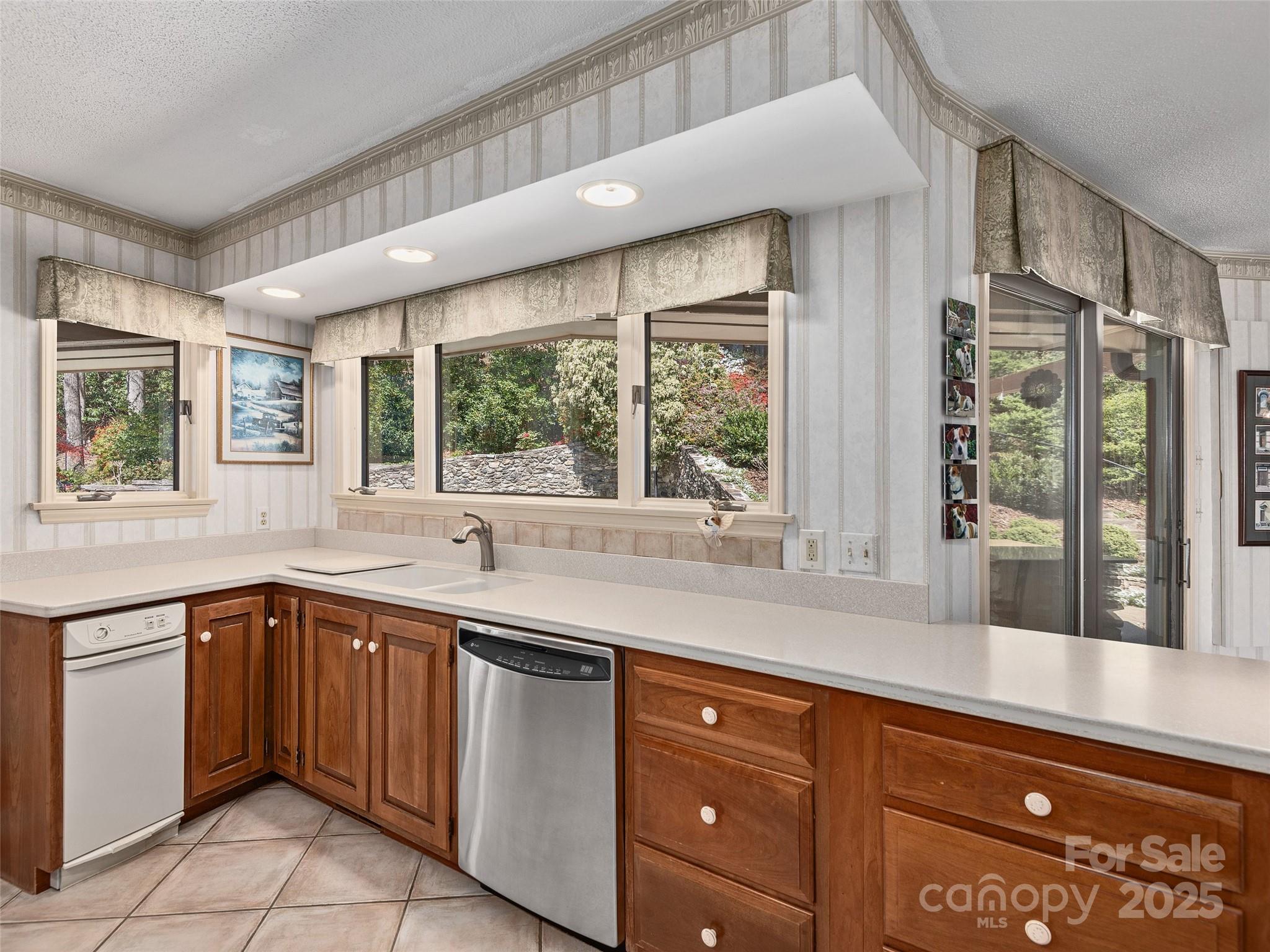 1300 Randy Drive Hendersonville, NC 28791 - Photo 13 of 48 a kitchen with a sink window and cabinets