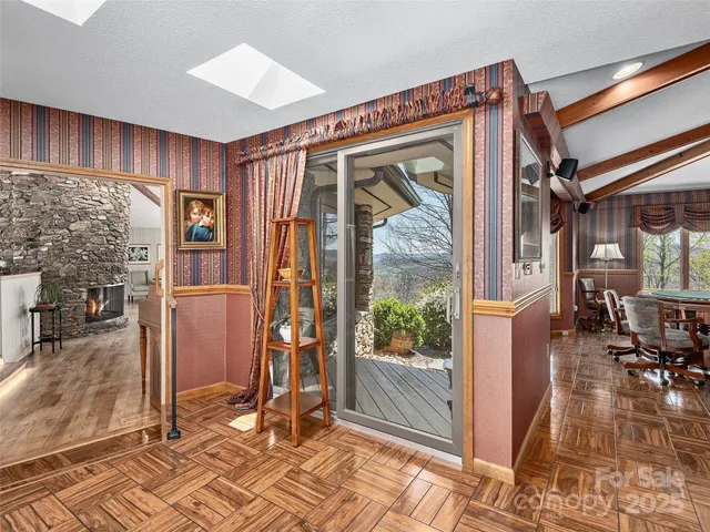 a balcony with furniture and a floor to ceiling window