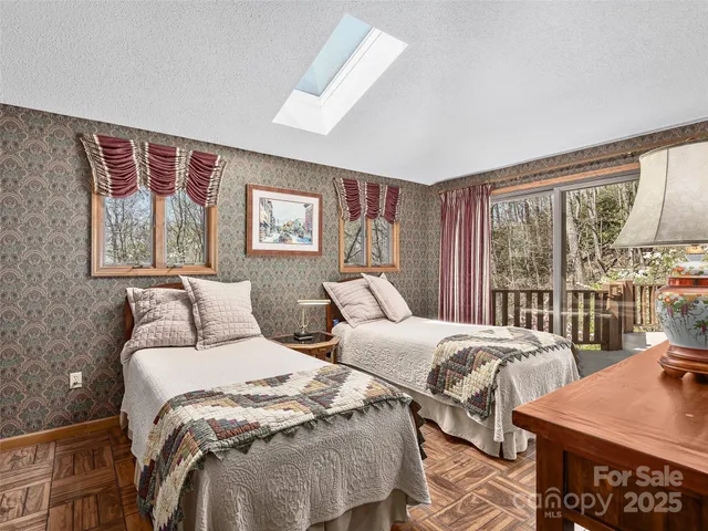 a view of a park with potted plants and large trees