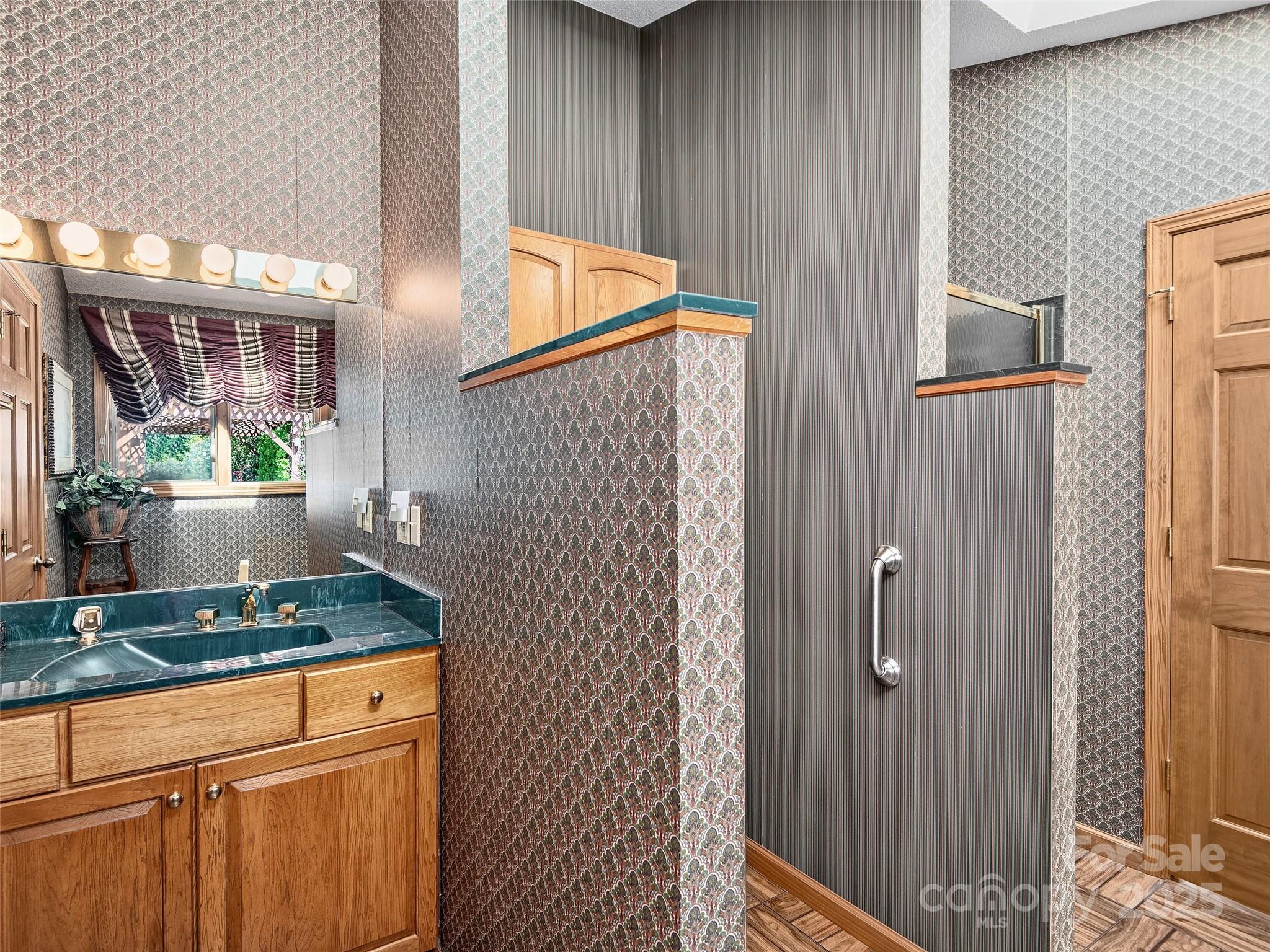 1300 Randy Drive Hendersonville, NC 28791 - Photo 21 of 48 a bathroom with a granite countertop sink and a mirror
