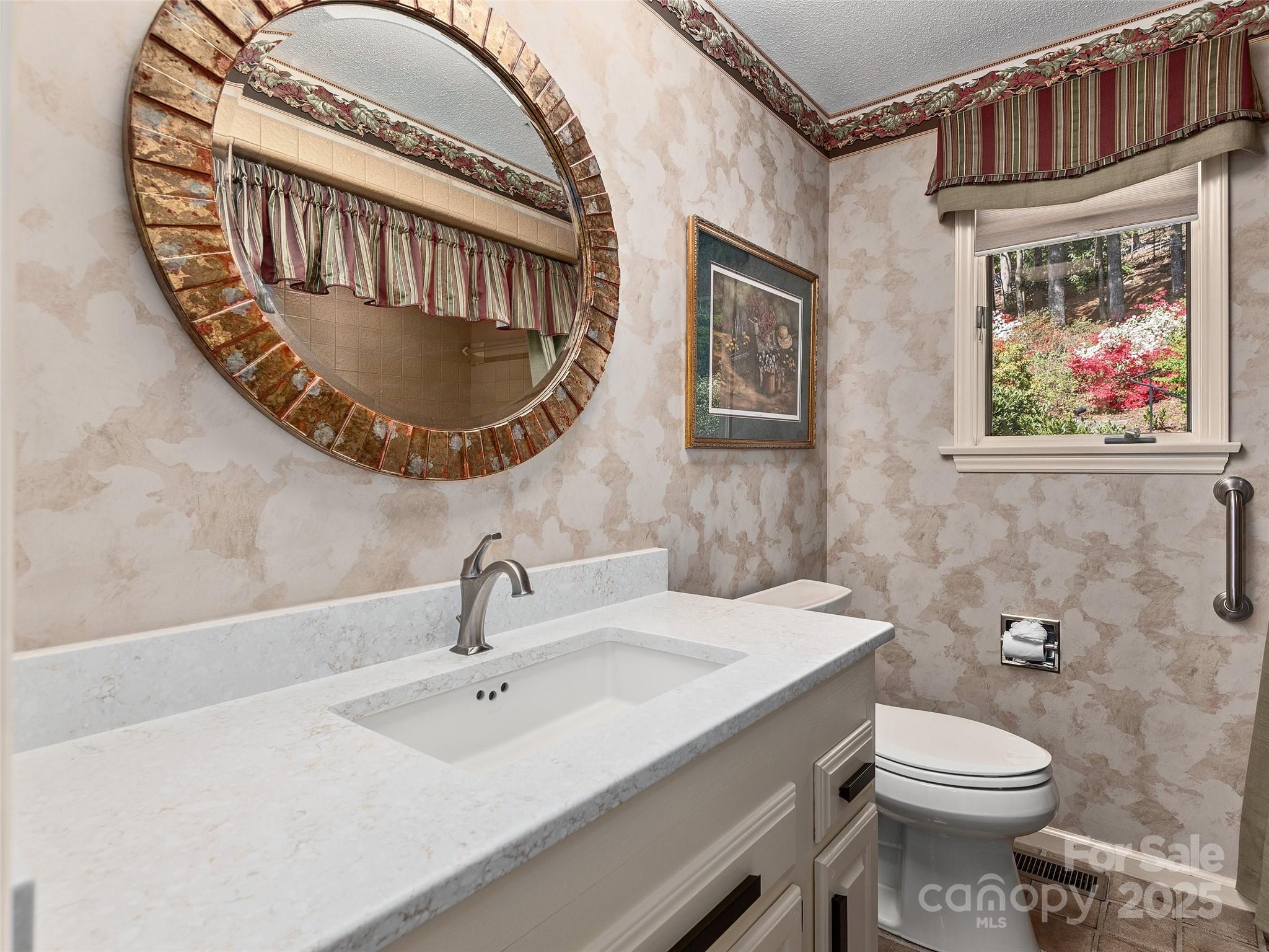 1300 Randy Drive Hendersonville, NC 28791 - Photo 29 of 48 a bathroom with a sink a toilet and a mirror
