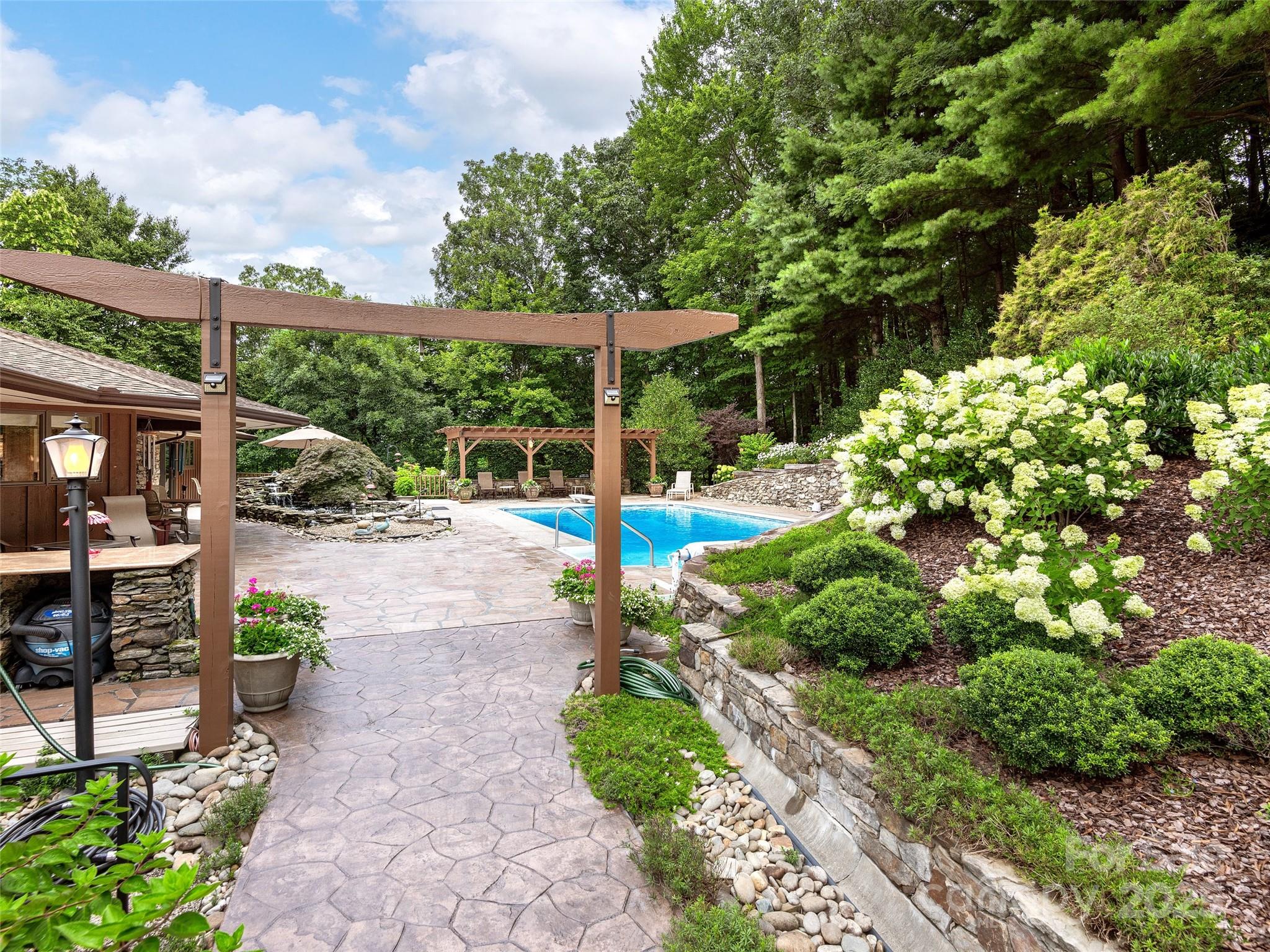 1300 Randy Drive Hendersonville, NC 28791 - Photo 35 of 48 a view of a park with potted plants and large trees