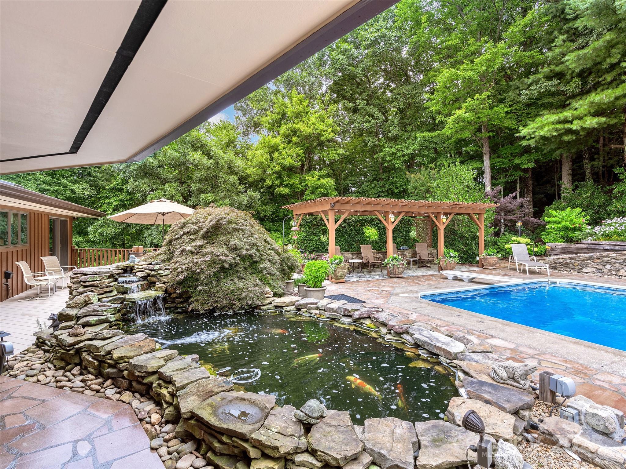 1300 Randy Drive Hendersonville, NC 28791 - Photo 37 of 48 a view of a backyard with furniture and garden