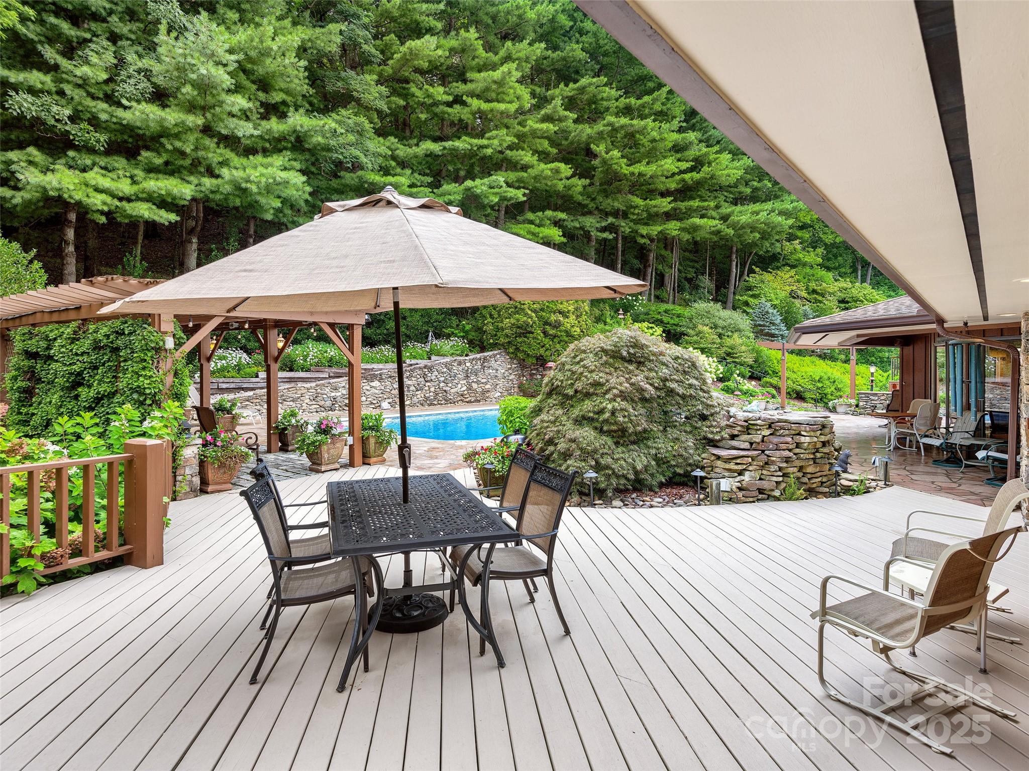 1300 Randy Drive Hendersonville, NC 28791 - Photo 39 of 48 a view of patio with table and chairs under an umbrella