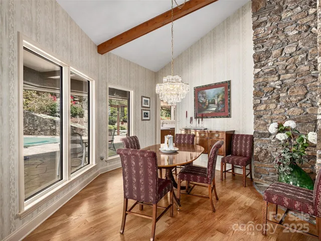a living room with furniture a flat screen tv and kitchen view