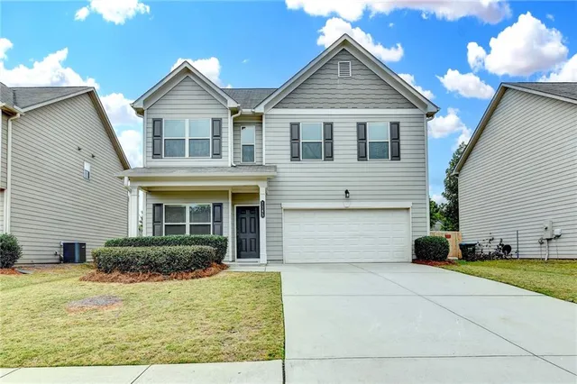 a front view of a house with a yard