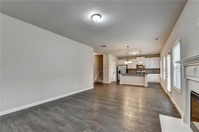 a view of kitchen with refrigerator microwave and stove