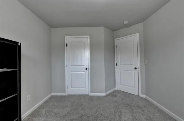 a view of an empty room and closet area