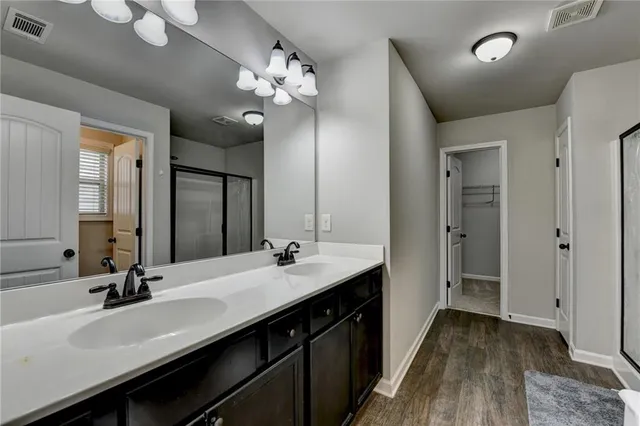 a bathroom with a sink double vanity and a mirror