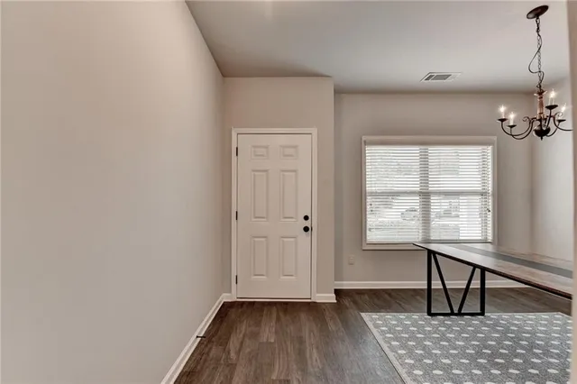 a view of a livingroom with wooden floor and a window
