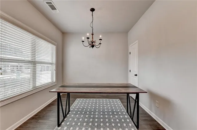 a view of a room with wooden floor and windows