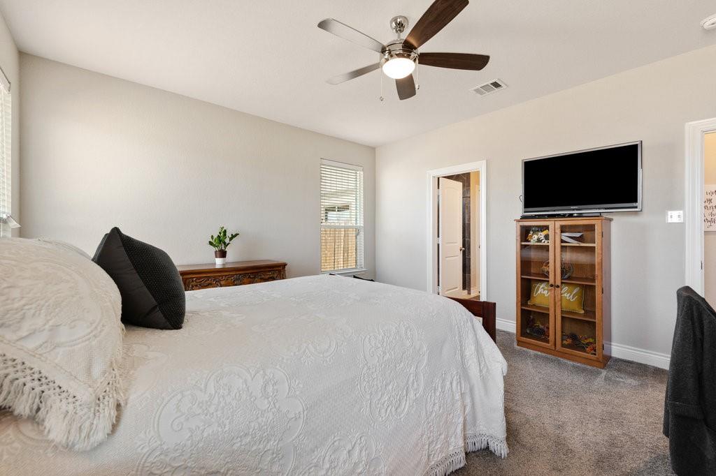2471 Sunrise Road, Unit 16 Round Rock, TX 78664 - Photo 17 of 28 a bedroom with a bed and a flat screen tv