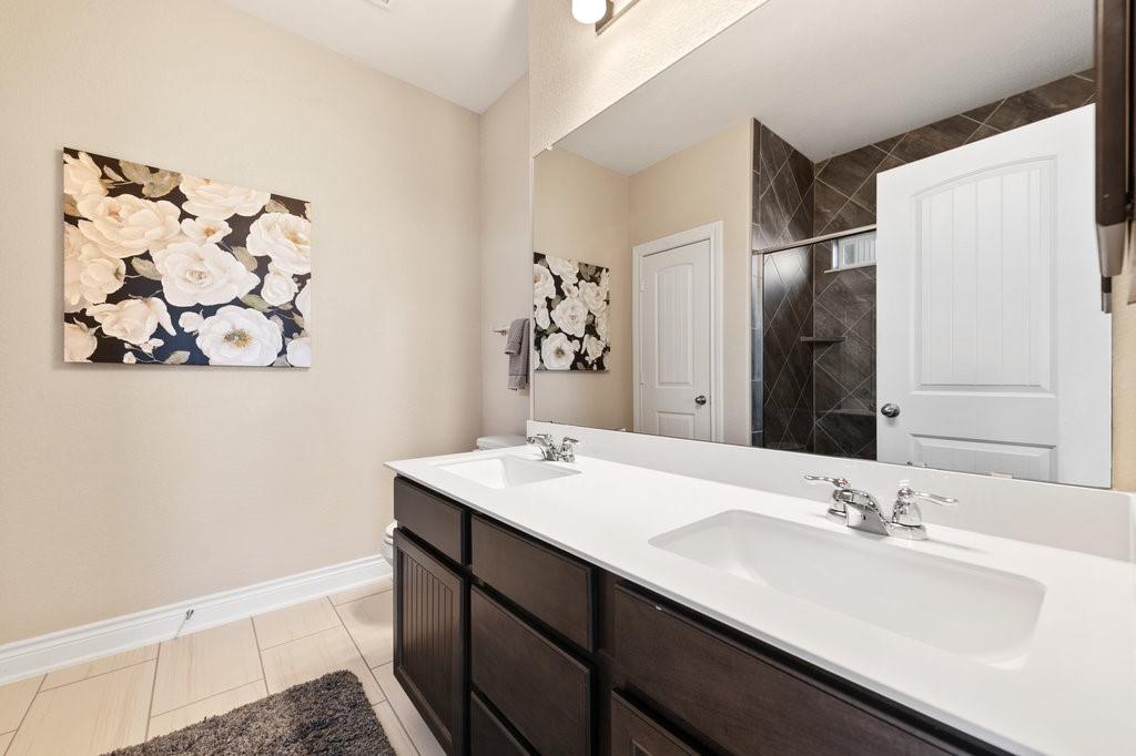 2471 Sunrise Road, Unit 16 Round Rock, TX 78664 - Photo 18 of 28 a bathroom with a sink and a mirror