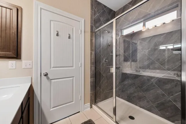 a bathroom with a shower and a sink