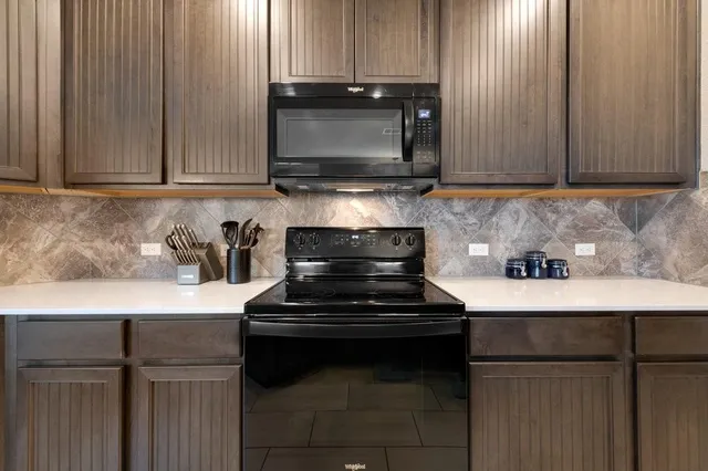 a kitchen with a stove and a microwave