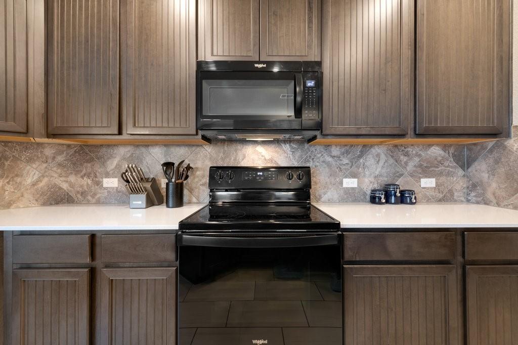 2471 Sunrise Road, Unit 16 Round Rock, TX 78664 - Photo 8 of 28 a kitchen with a stove and a microwave
