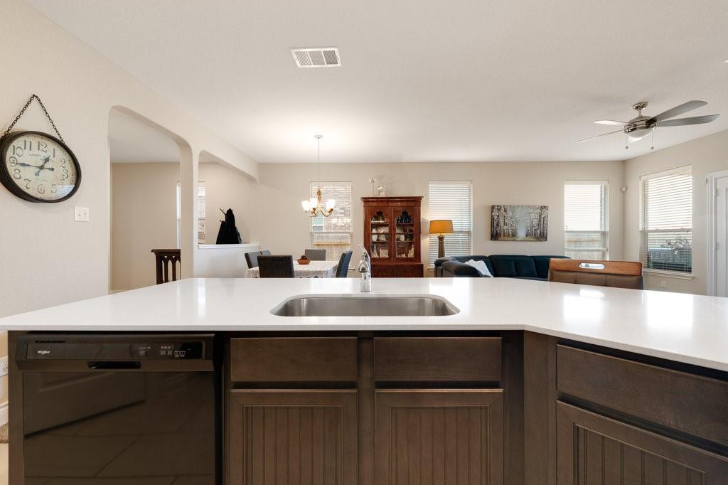 2471 Sunrise Road, Unit 16 Round Rock, TX 78664 - Photo 9 of 28 a kitchen with a sink and a stove with wooden floor