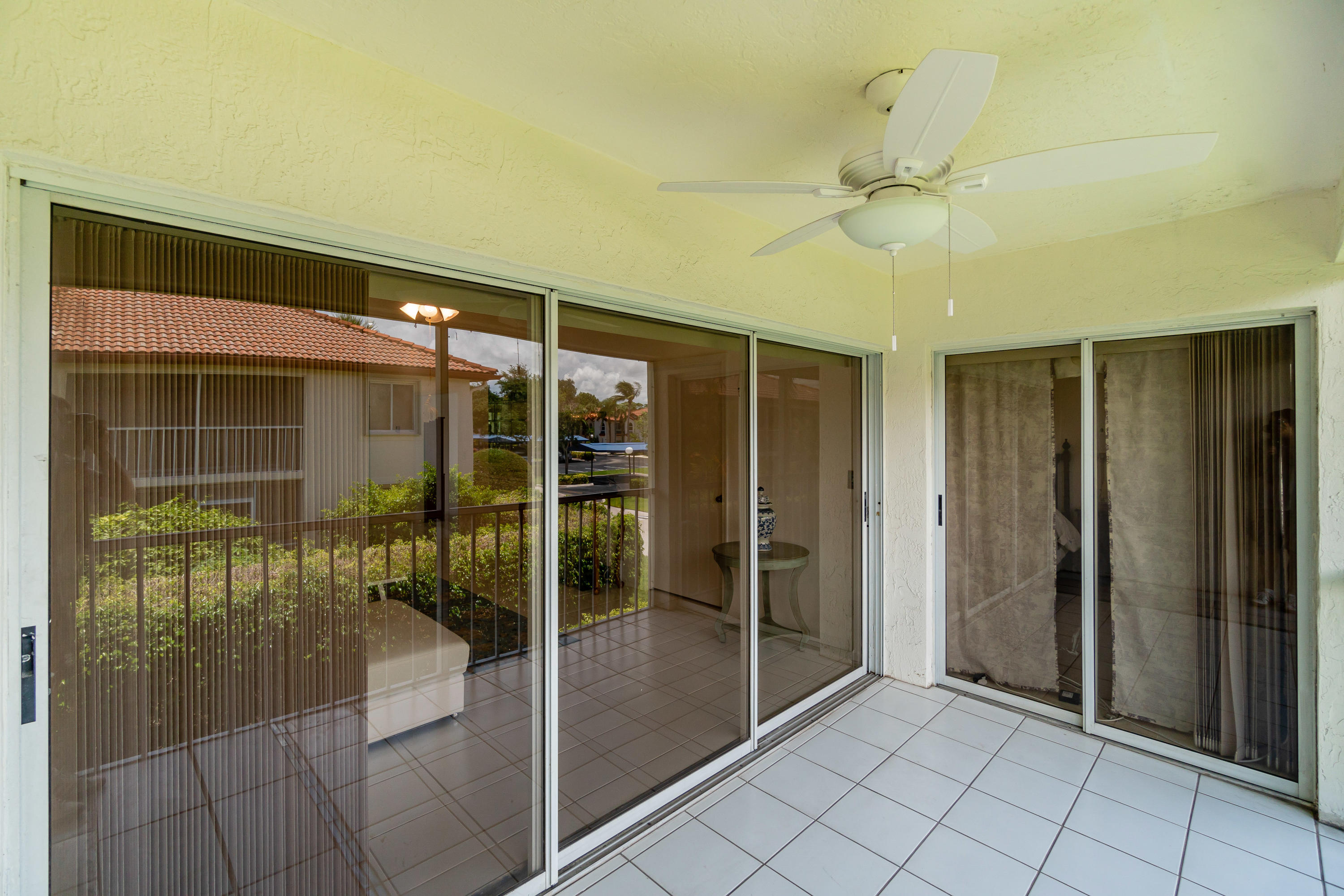 340 Northwest 67th Street, Unit 201 Boca Raton, FL 33487 - Photo 32 of 46 Screened balcony