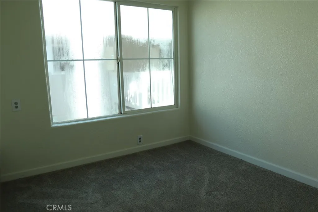 1855 East Riverside Drive, Unit 48 Ontario, CA 91761 - Photo 13 of 20 a view of an empty room with a window