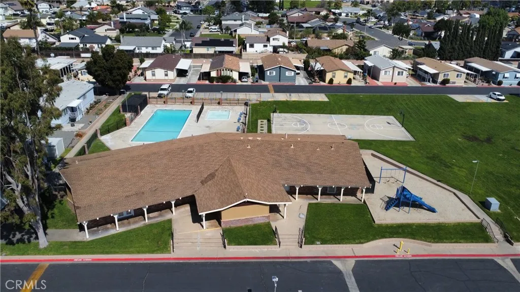 1855 East Riverside Drive, Unit 48 Ontario, CA 91761 - Photo 17 of 20 an aerial view of multiple houses with a yard