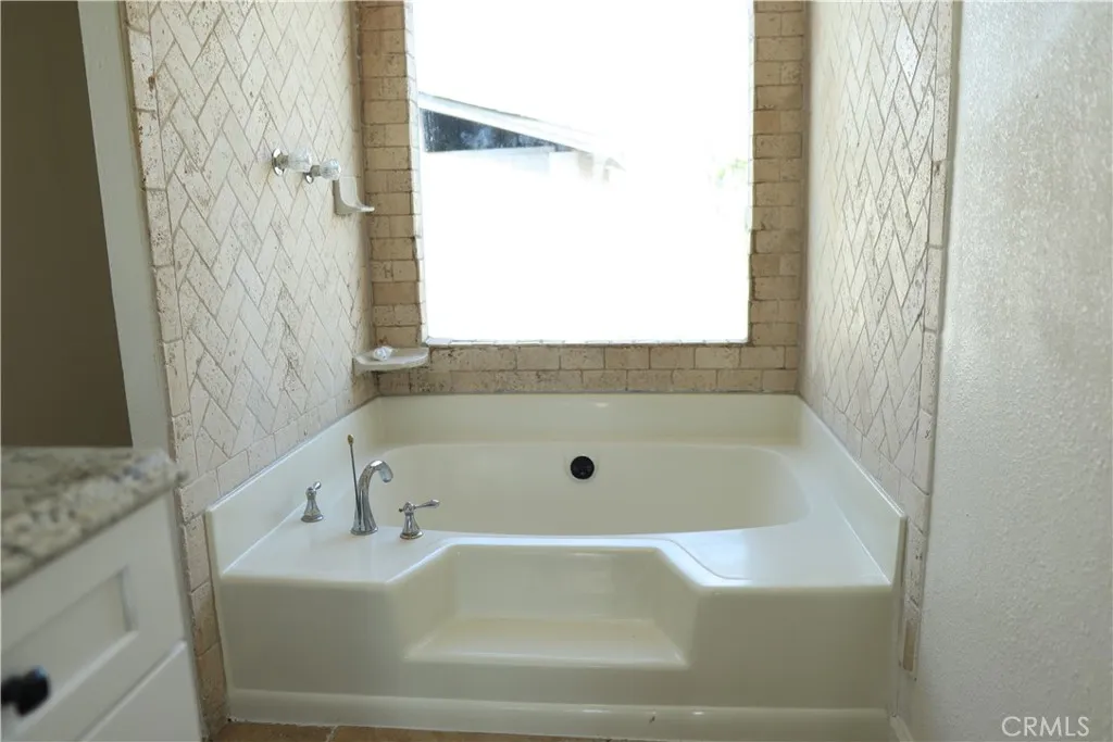 1855 East Riverside Drive, Unit 48 Ontario, CA 91761 - Photo 8 of 20 a bathroom with a bathtub and shower