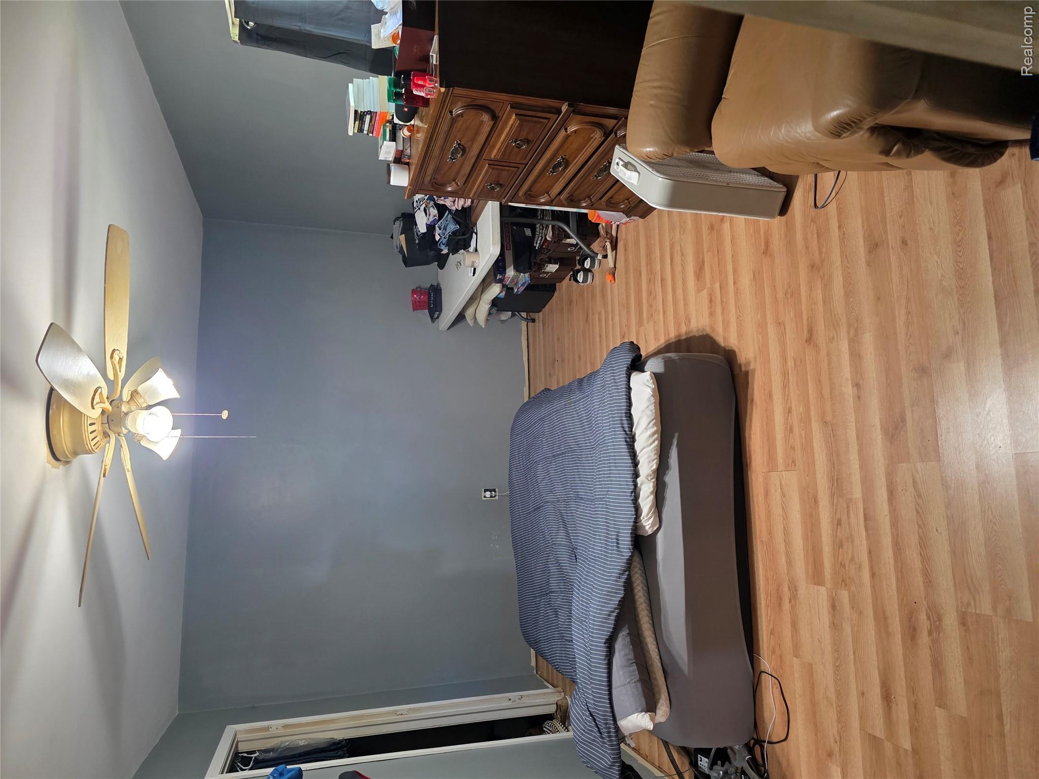 4217 Pengelly Road Flint, MI 48507 - Photo 23 of 26 Room featuring wood-finish flooring, a ceiling fan with integrated lighting, and a closet with a bifold door
