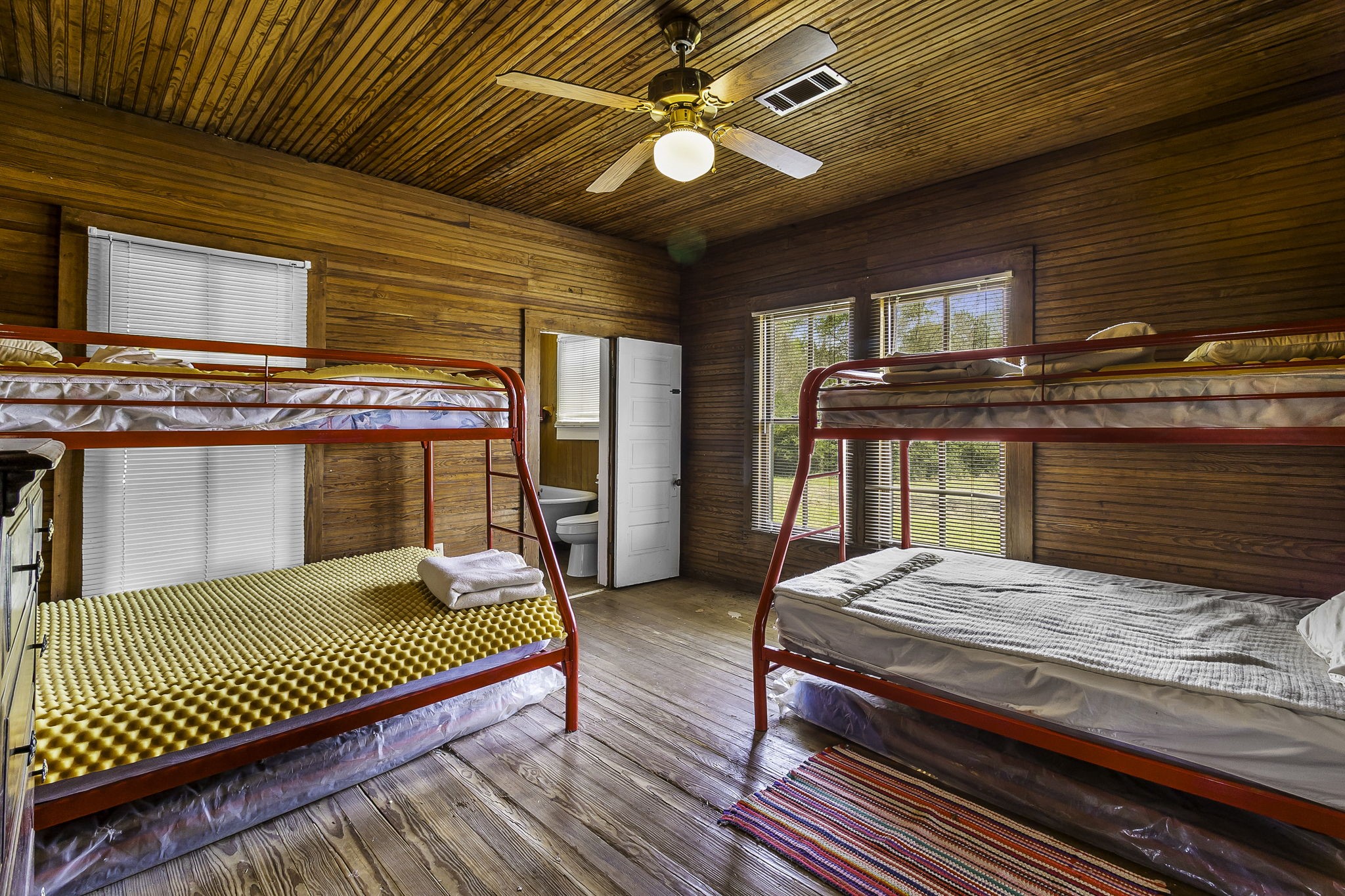 2 Triple Creek Loop Livingston, TX 77351 - Photo 15 of 49 a bedroom with a bed and a chandelier