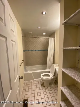 a bathroom with a sink toilet and a mirror