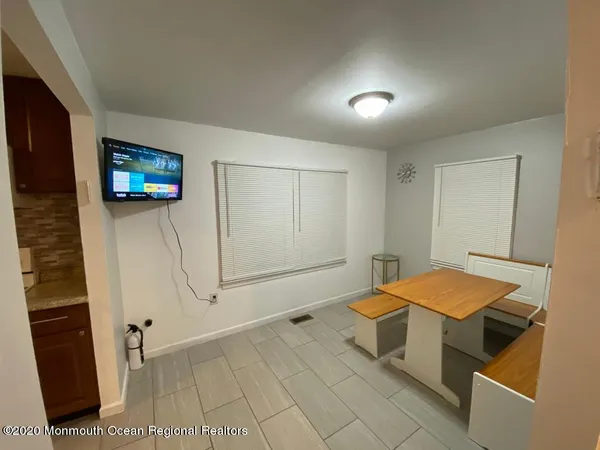 a room with pool table and a wooden floor