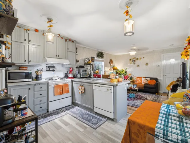 a kitchen that has a lot of cabinets in it and appliances