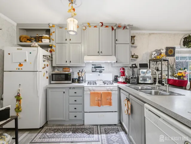 a kitchen with stainless steel appliances granite countertop a sink a stove and cabinets