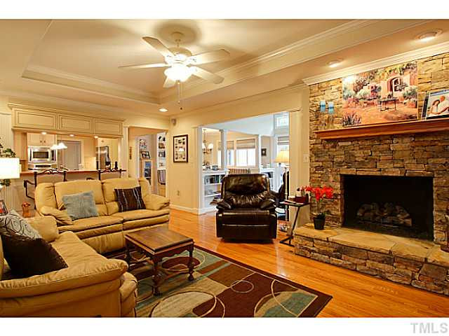 4701 Stiller Street Raleigh, NC 27609 - Photo 5 of 25 Family room with masonry fireplace opens to kitchen and sunroom. Den/Family/Great Room