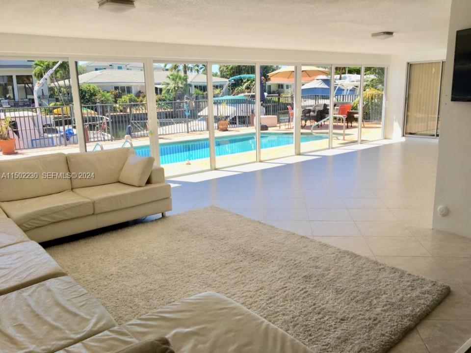 3741 Northeast 25th Avenue Lighthouse Point, FL 33064 - Photo 2 of 2 a living room with furniture and a floor to ceiling window