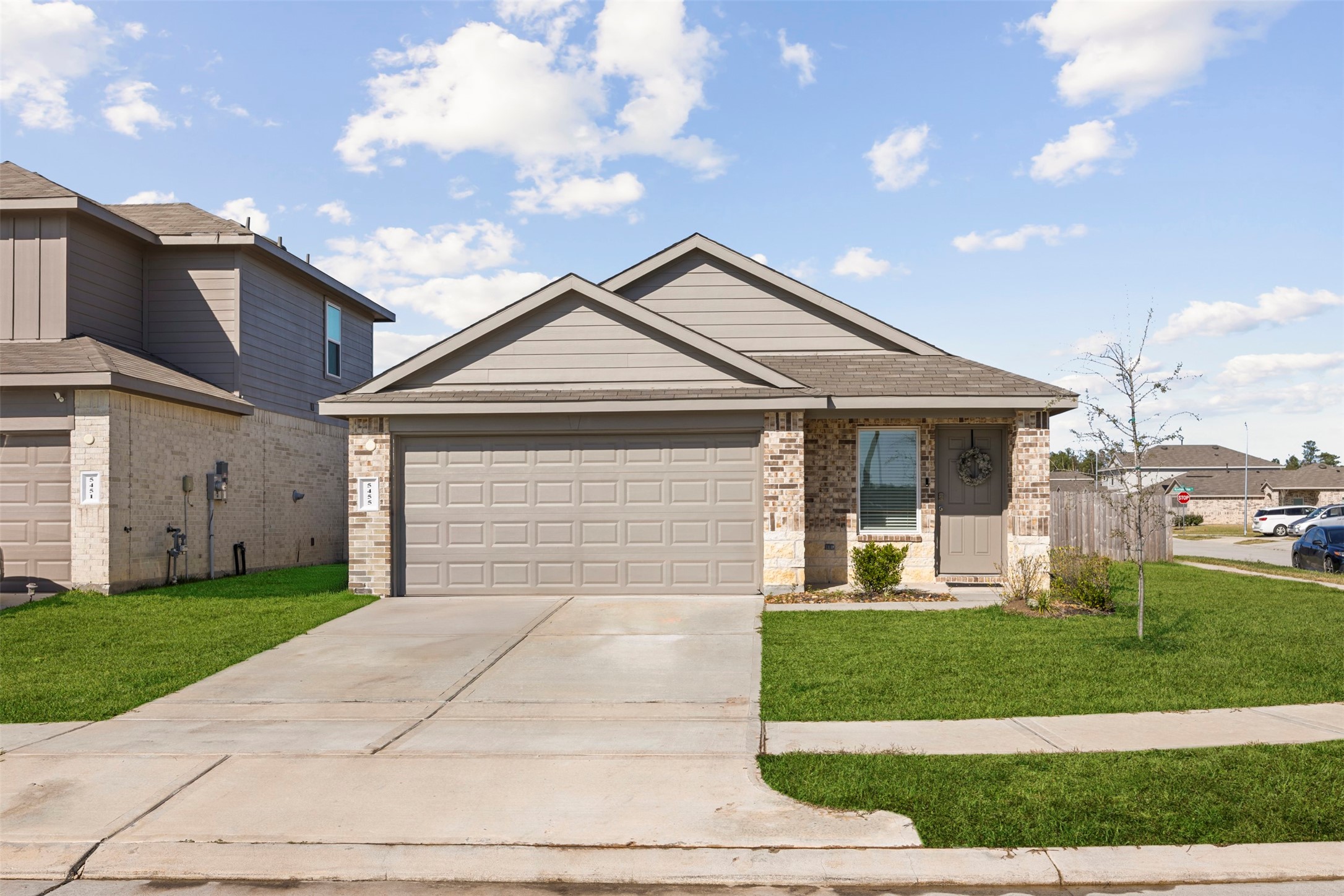 a front view of a house with a yard and garage