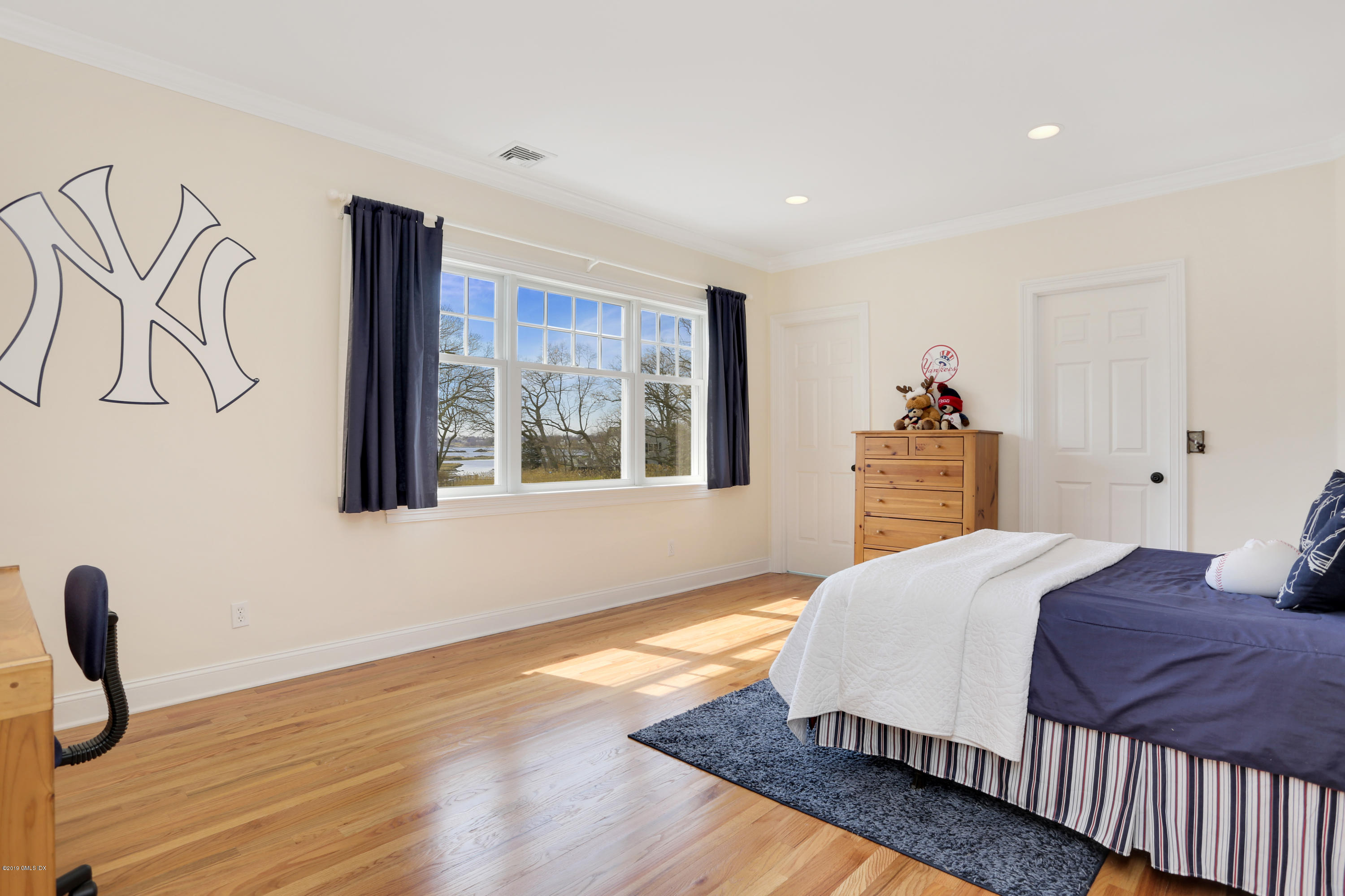 4 Highgate Road Riverside, CT 06878 - Photo 19 of 33 a bedroom with a bed and wooden floor