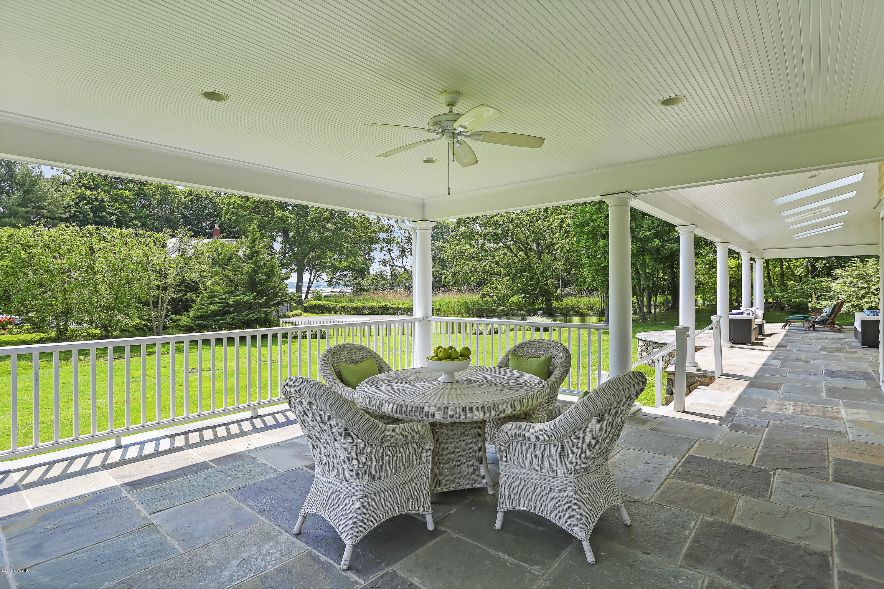 4 Highgate Road Riverside, CT 06878 - Photo 2 of 33 a patio with yard table and chairs
