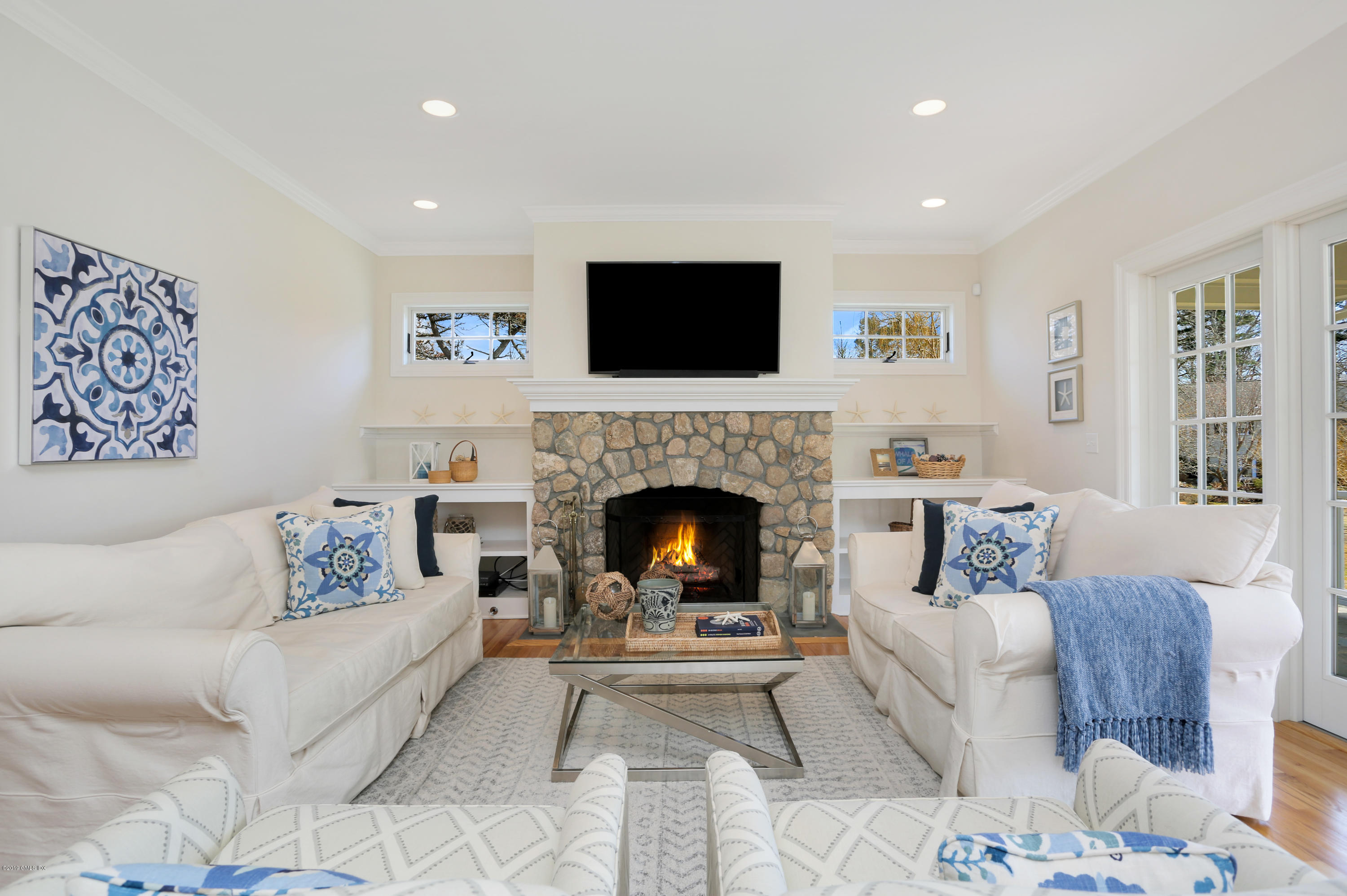 4 Highgate Road Riverside, CT 06878 - Photo 8 of 33 a living room with furniture a flat screen tv and a fireplace